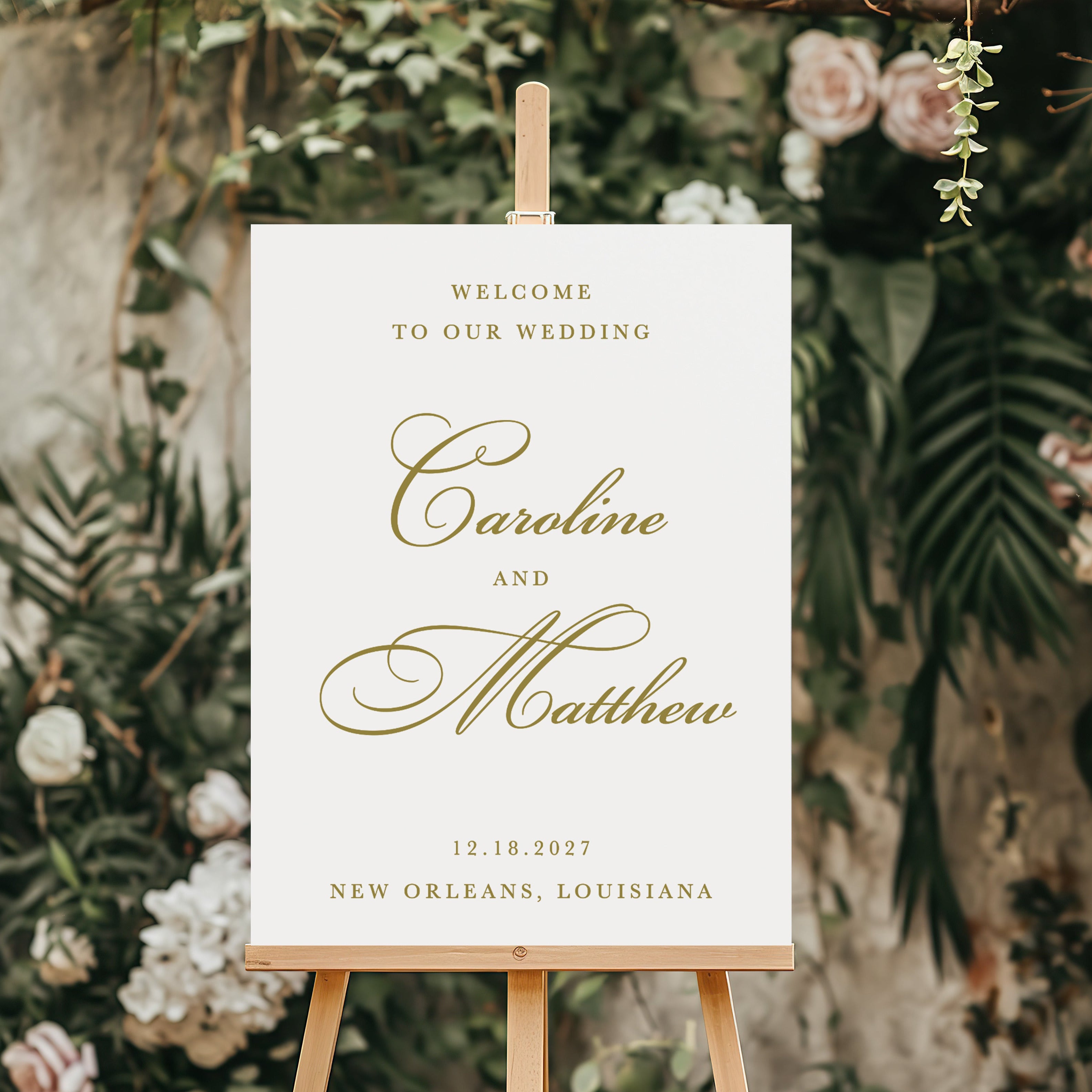 Wedding welcome sign on an easel with floral and greenery background