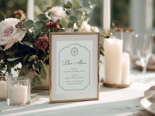Decorative table setting with flowers, candles, and a bar menu sign.