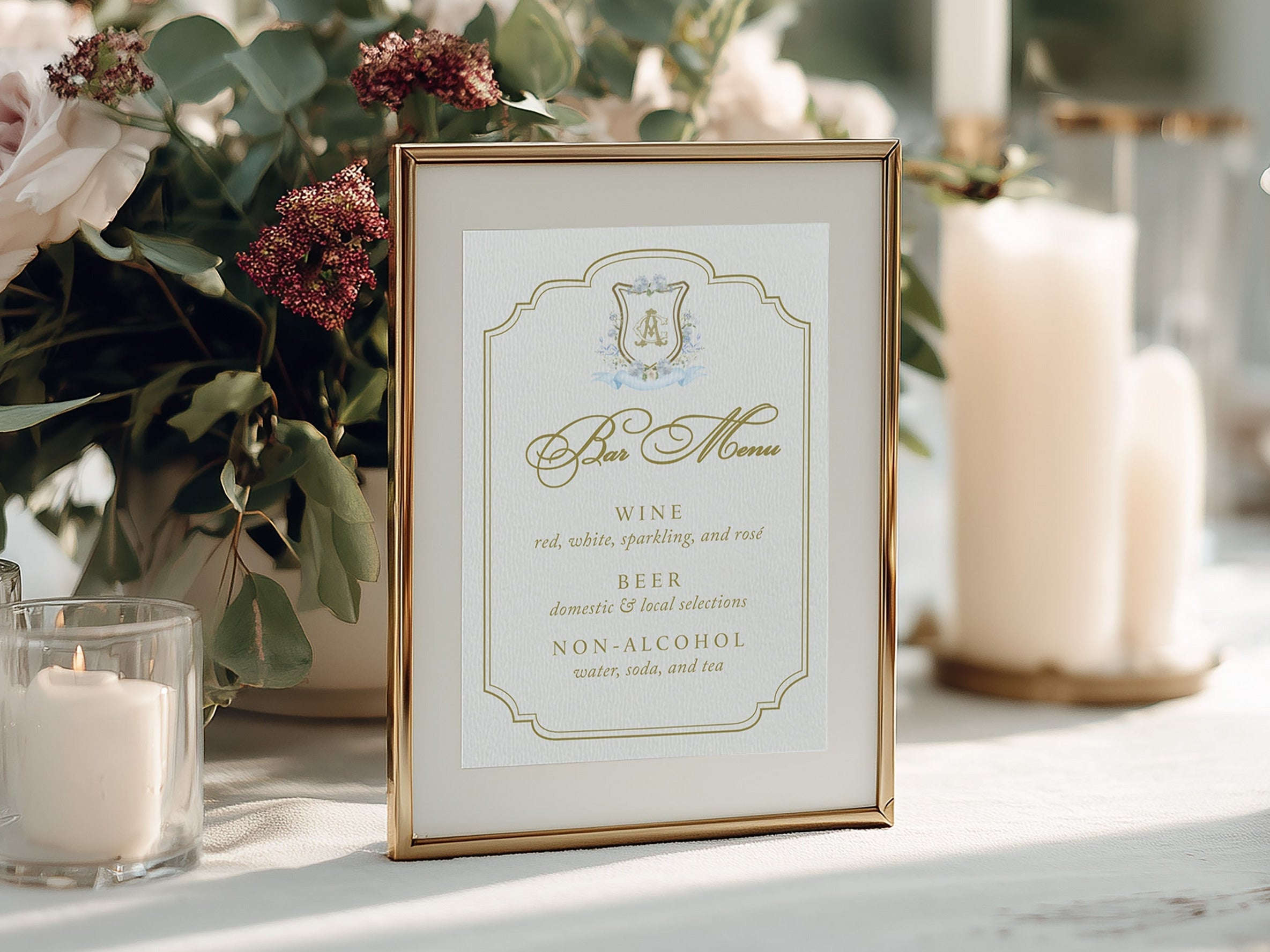 Decorative table setting with flowers, candles, and a bar menu sign.