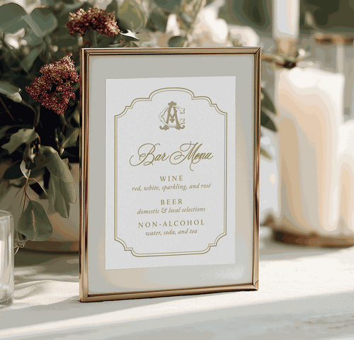 Framed bar menu on a table with floral decorations and candles