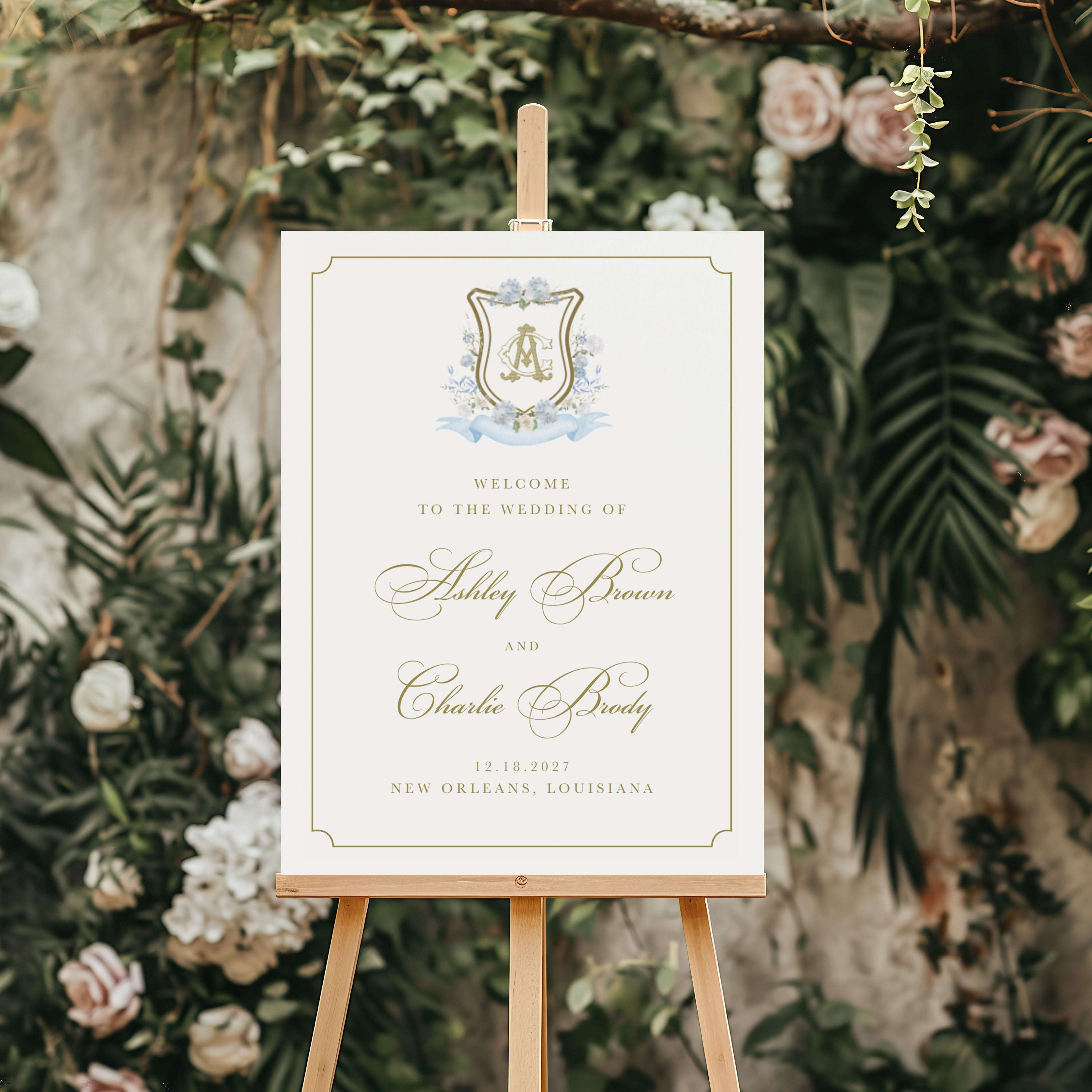 Wedding welcome sign on an easel with floral and greenery background