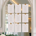 White cards with gold buttons on a decorative mirror