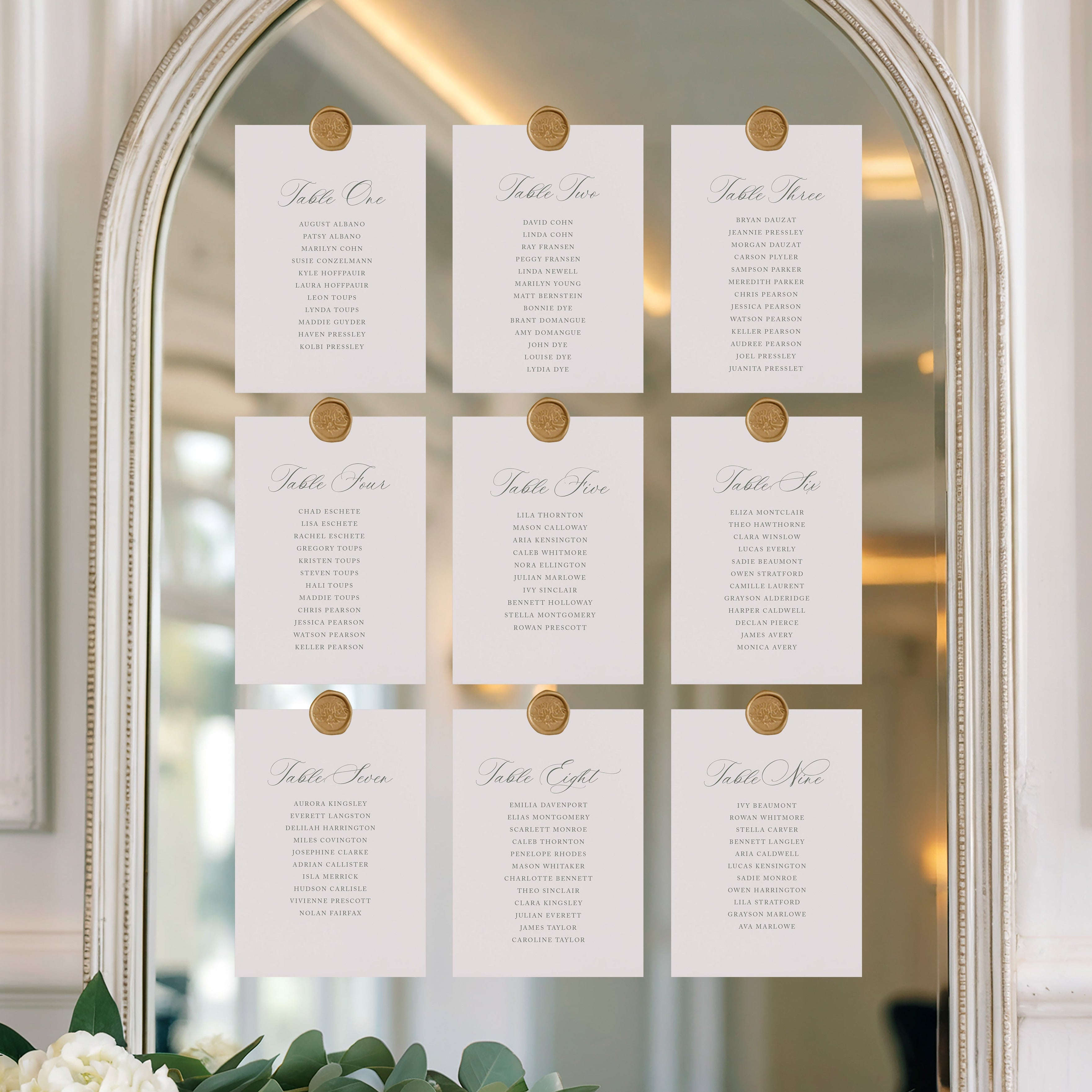 White cards with gold buttons on a decorative mirror