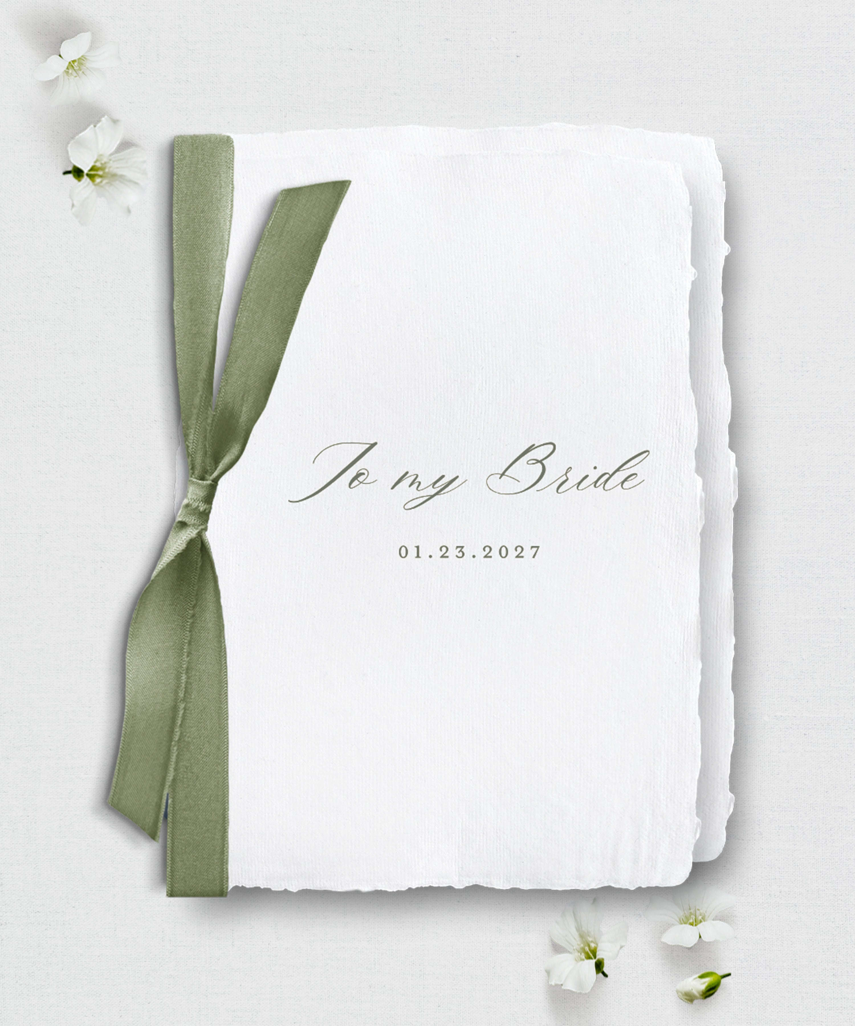 handmade paper wedding vow book with green ribbon