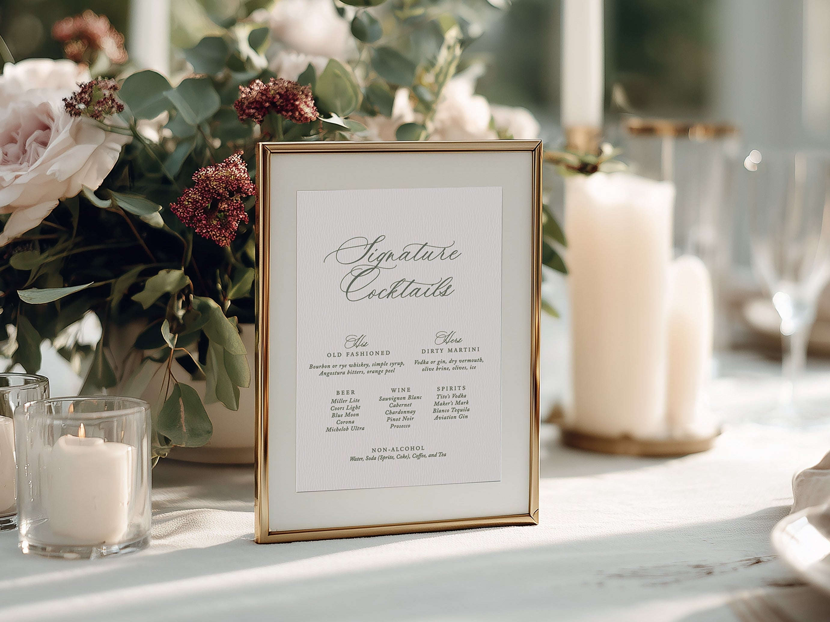Decorative table setting with flowers, candles, and a bar menu sign.