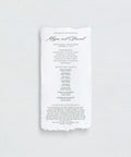 Handmade paper wedding program on a white background
