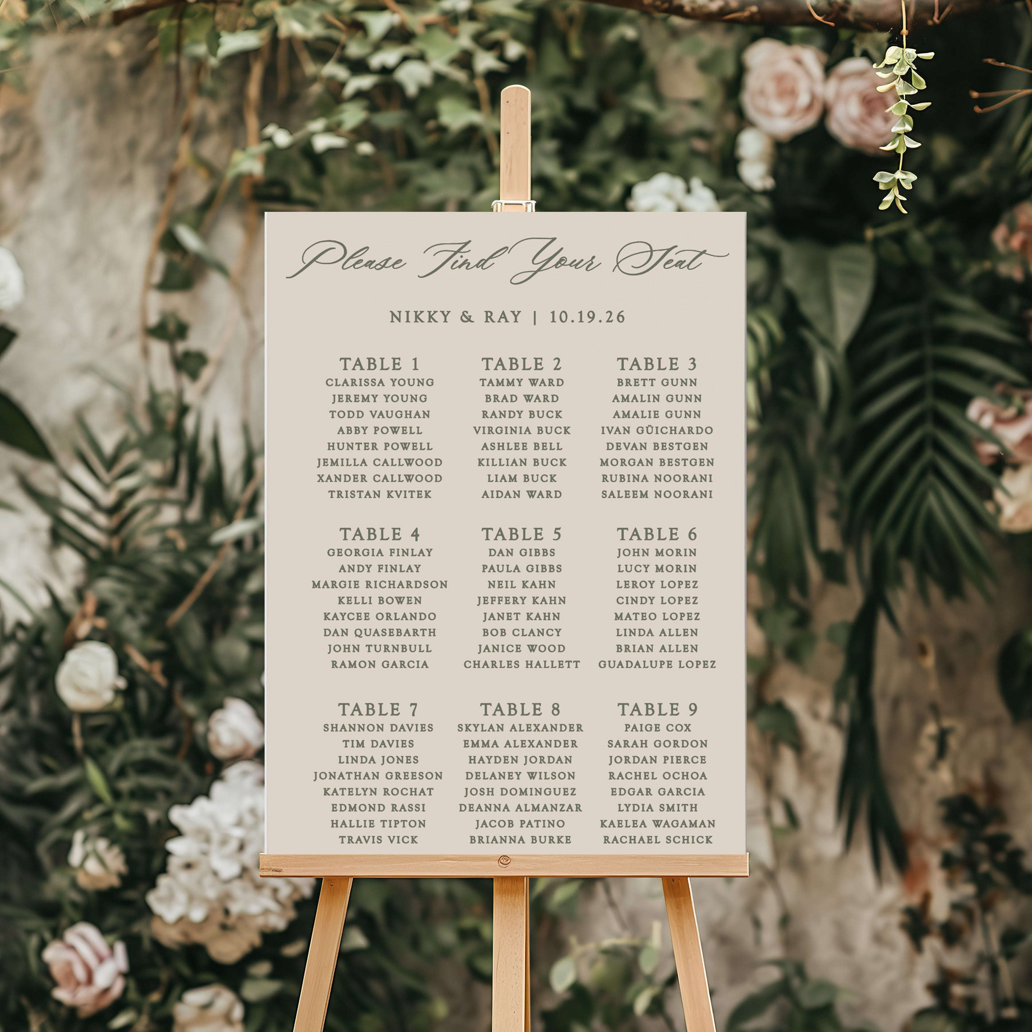 Wedding welcome sign on an easel with floral and greenery background