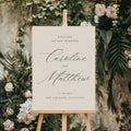 Wedding welcome sign on an easel with floral and greenery background
